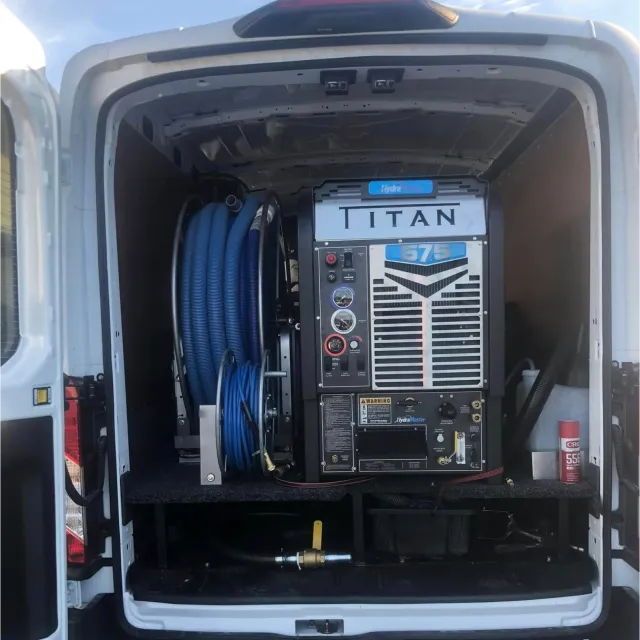 Van-mounted carpet cleaning equipment and hose reels